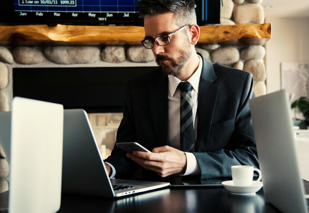 Man in Black Holding Phone